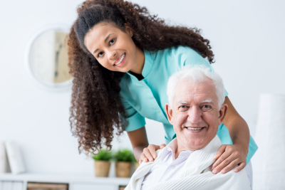 caregiver and senior woman are smiling